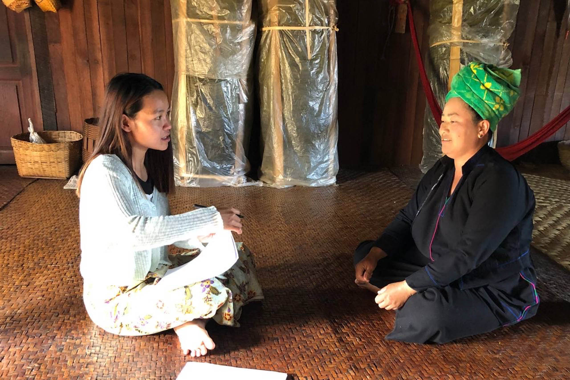 A female local research interviewed with woman avocado farmer for baseline research study in Inn Ni village, Shan State