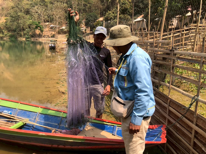 Field team checking sampling gear (gill nets) before collecting aquatic biological specimens along the riverbank. Photo by Maejo University