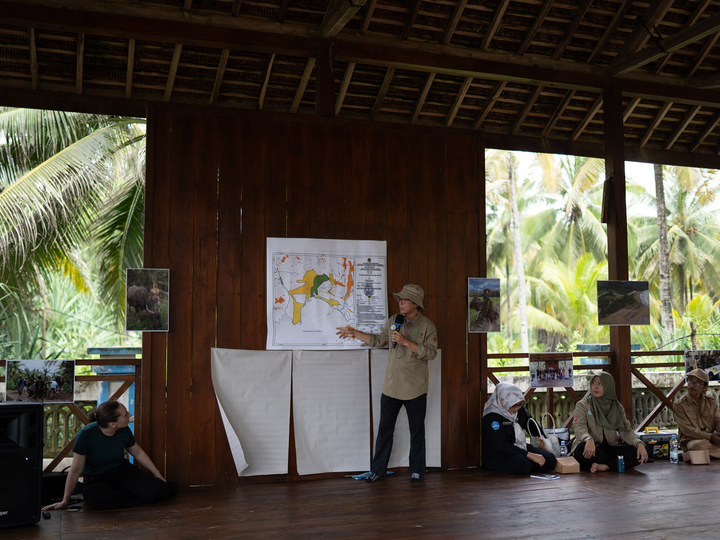 Rahmanta Setiahadi presents a map during social forestry fieldwork in East Java, Indonesia
