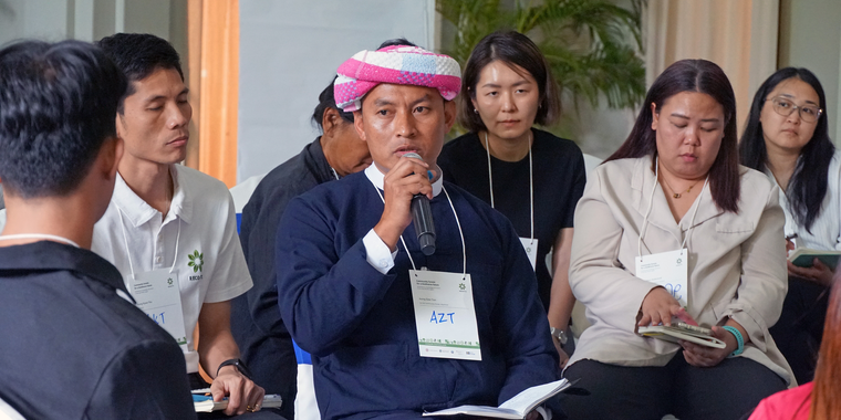 Indigenous Peoples speaking during a conference session on community forests and biodiversity.