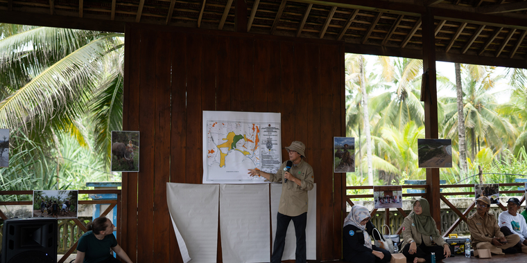 Rahmanta Setiahadi presents a map during social forestry fieldwork in East Java, Indonesia