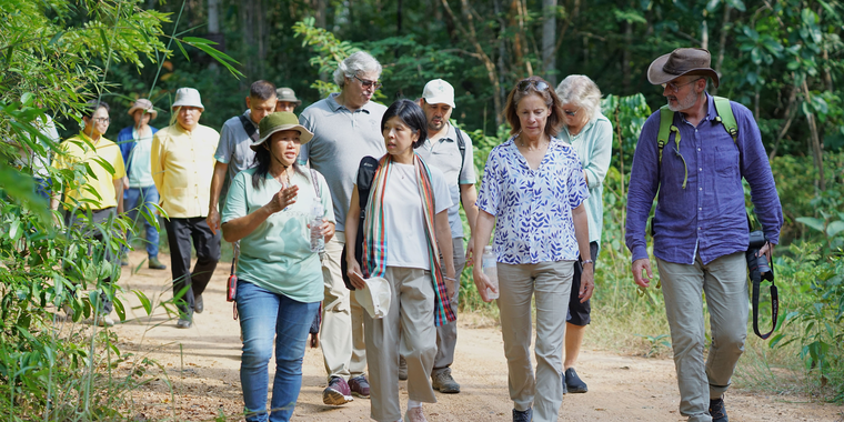 The ambassadors walked to Ban Pong Community Forest with Bua, the community forest leader.