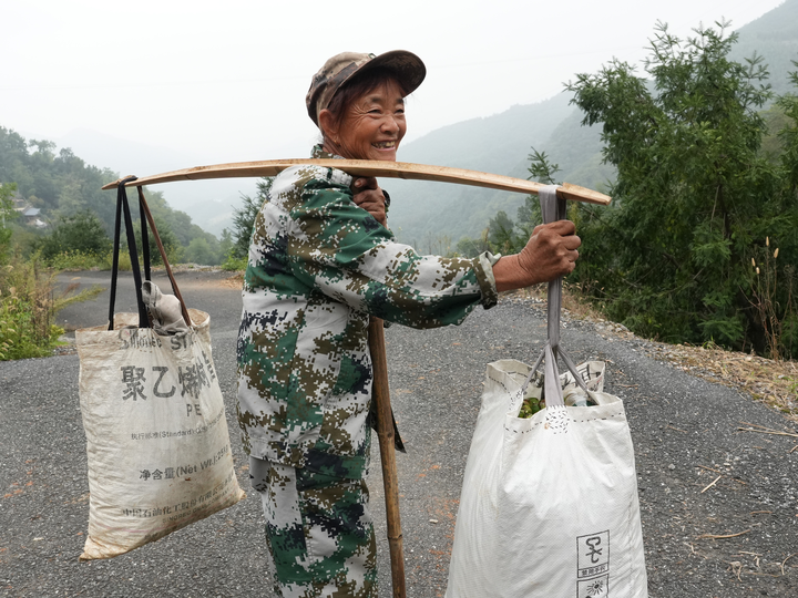 Cheerful nut gatherer showing her harvest