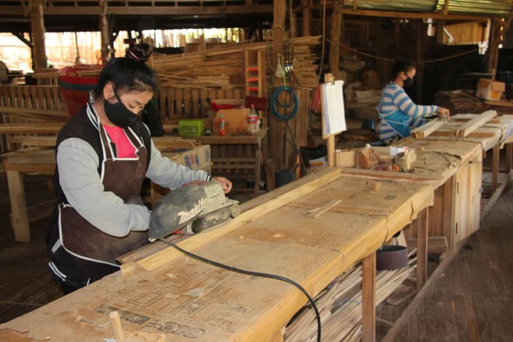 Women in Lao PDR wood processing factory sand wood