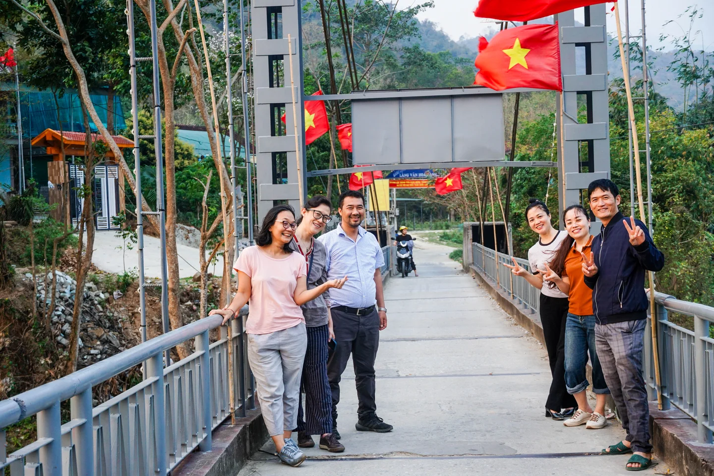 Marking the end of the field visit, team members pose at a suspension bridge on the Ca River.