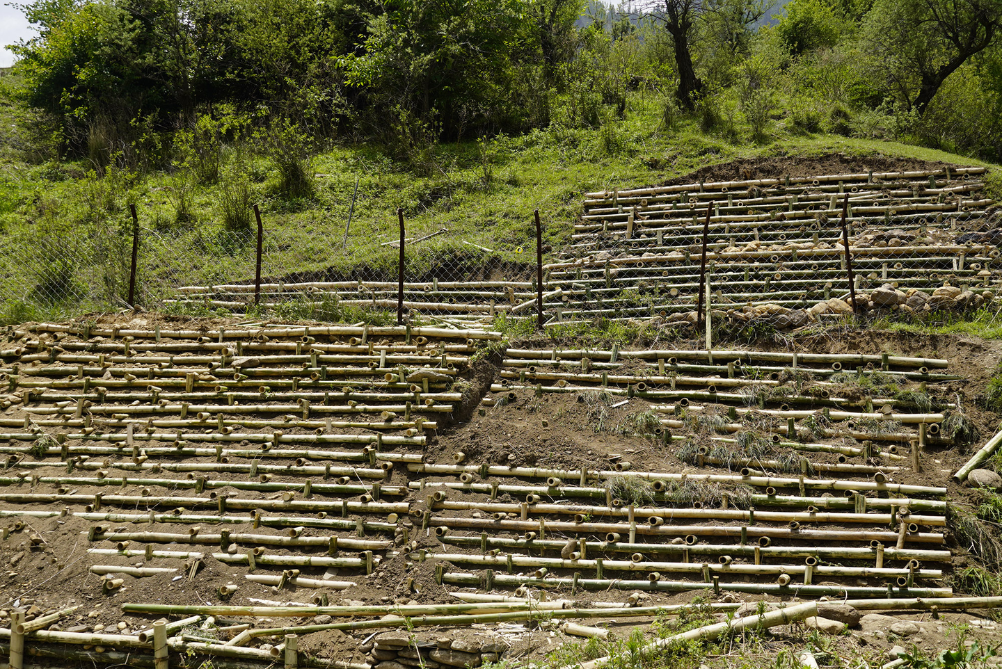 Construction of a crib-wall behind the powerhouse of the micro hydro plant. 