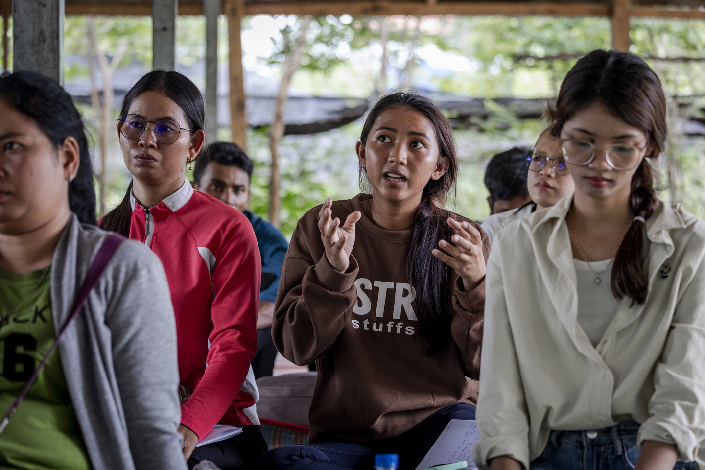 A participant engages in a training discussion with other participants.