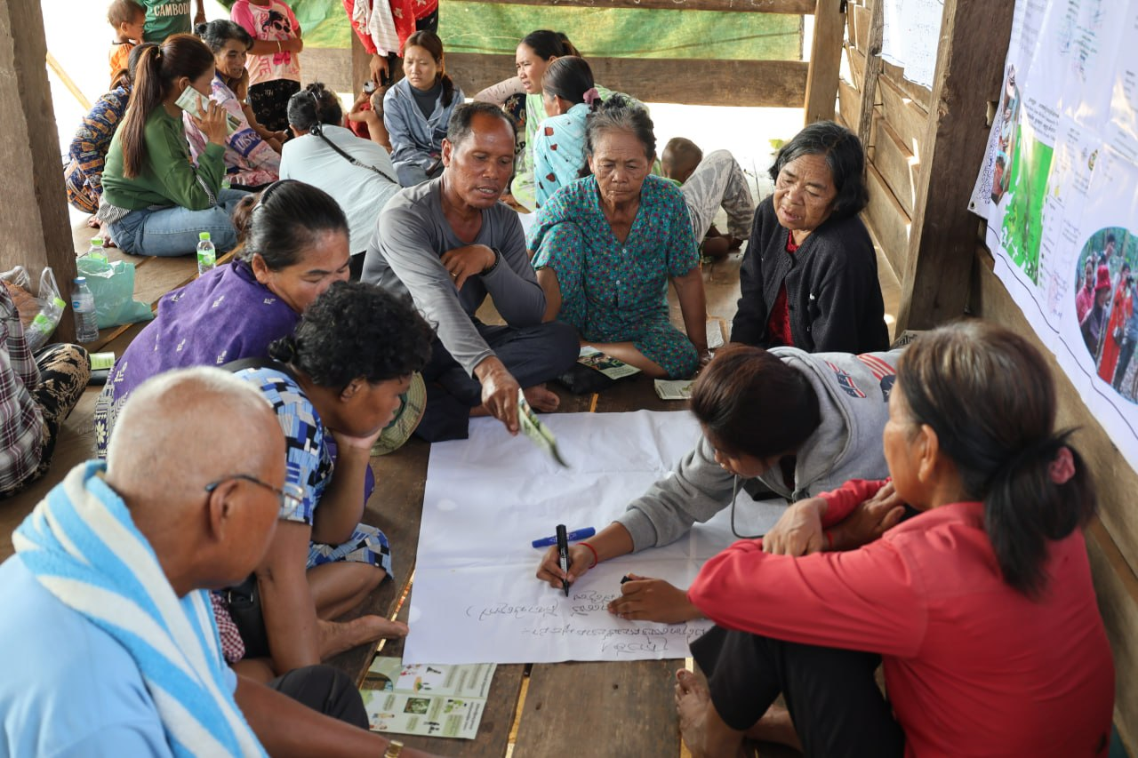 Cambodian youth (right) facilitating a community discussion on forest fires
