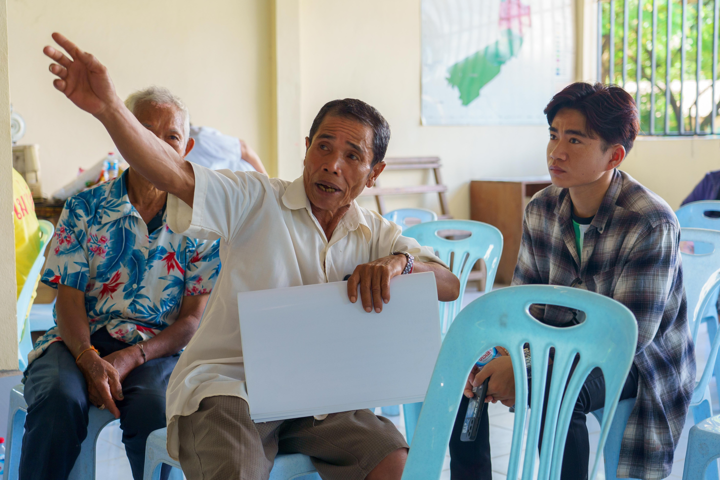 A community member speaks at a meeting with youth forest guardians.