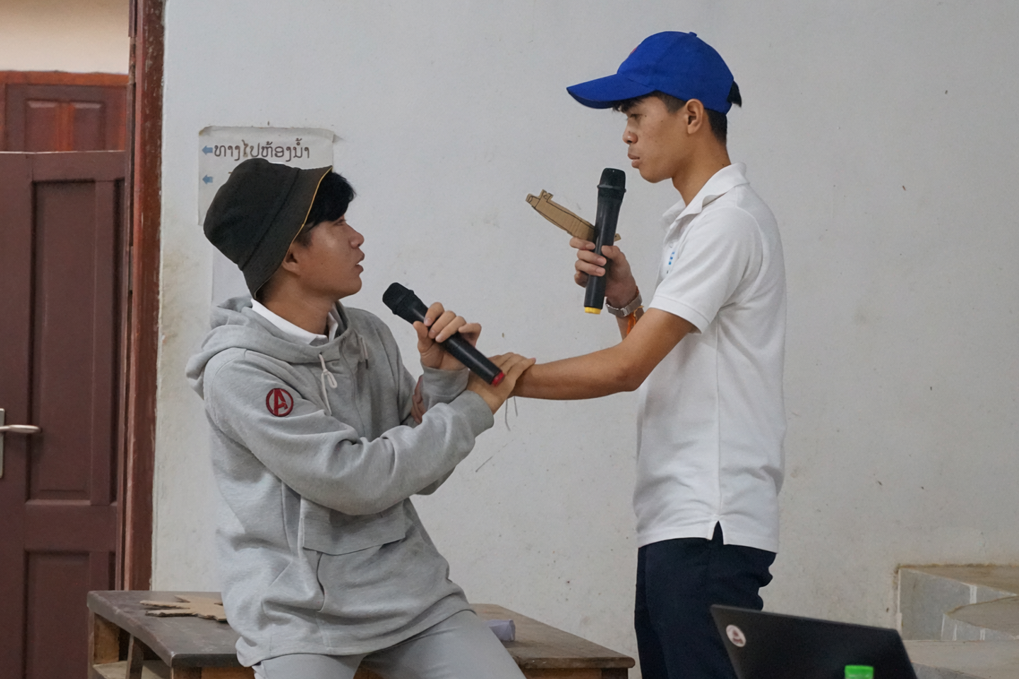Lao youth promoting wildlife conservation through role-play at a community event