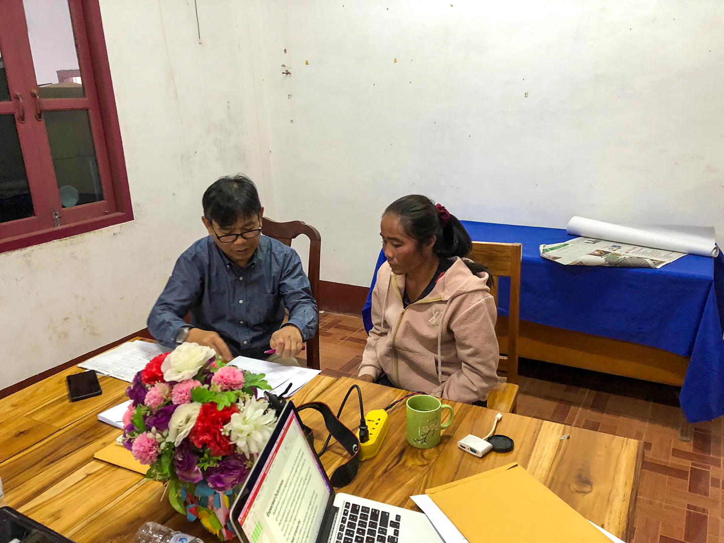 A researcher meets with a community member.