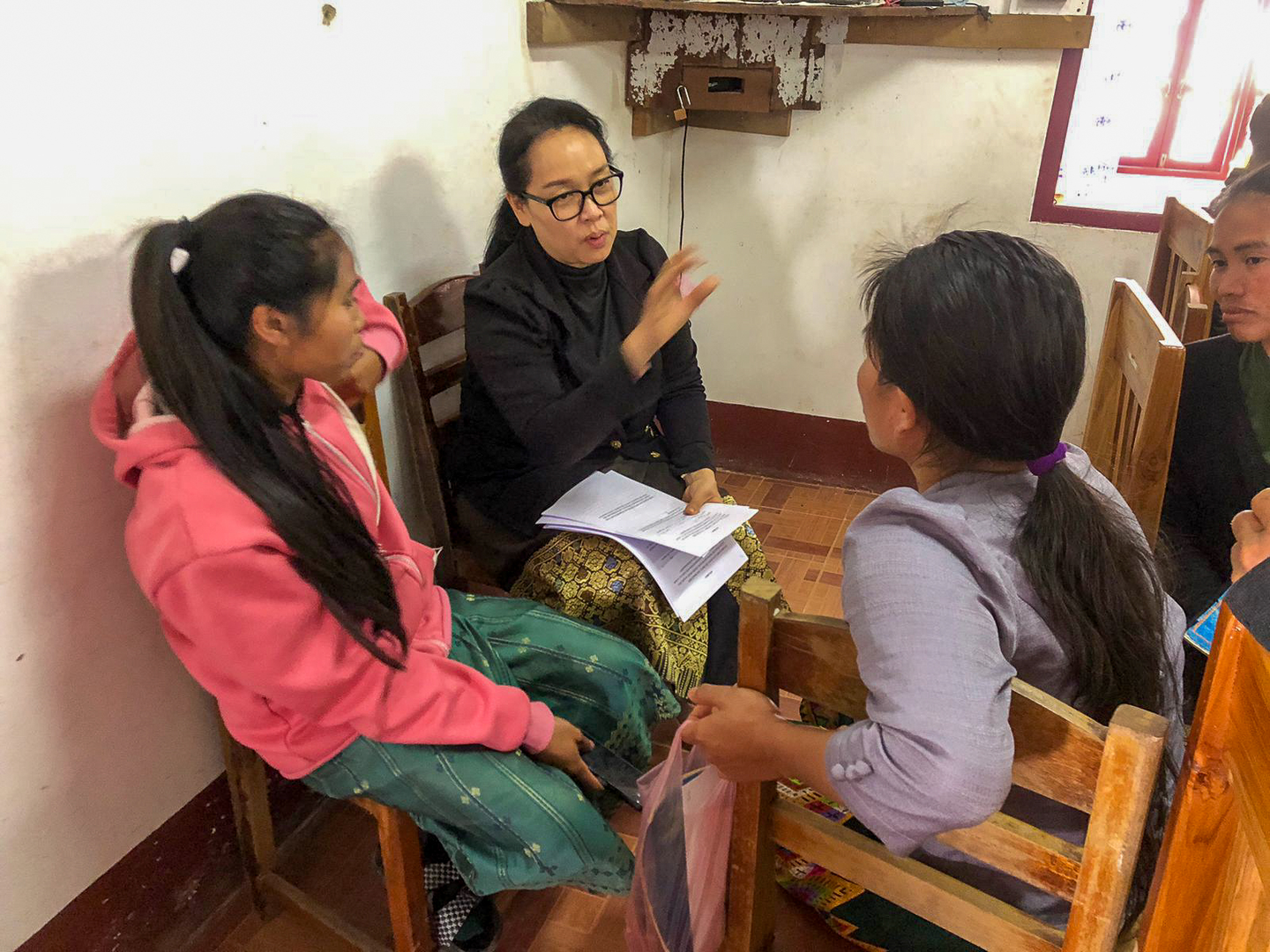 A researcher talks with community members.