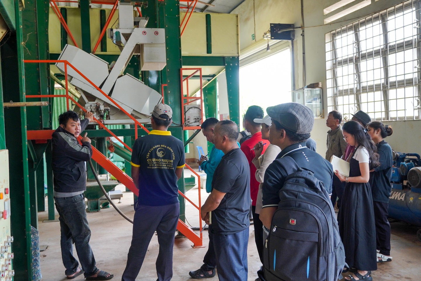 Coffee cooperative representatives visit a coffee processing facility in Dak Lak Province.