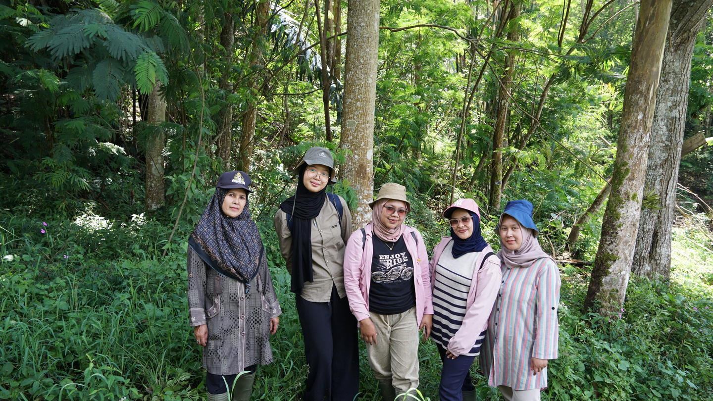 Coffee farmer with community data collection participants in Indonesia.
