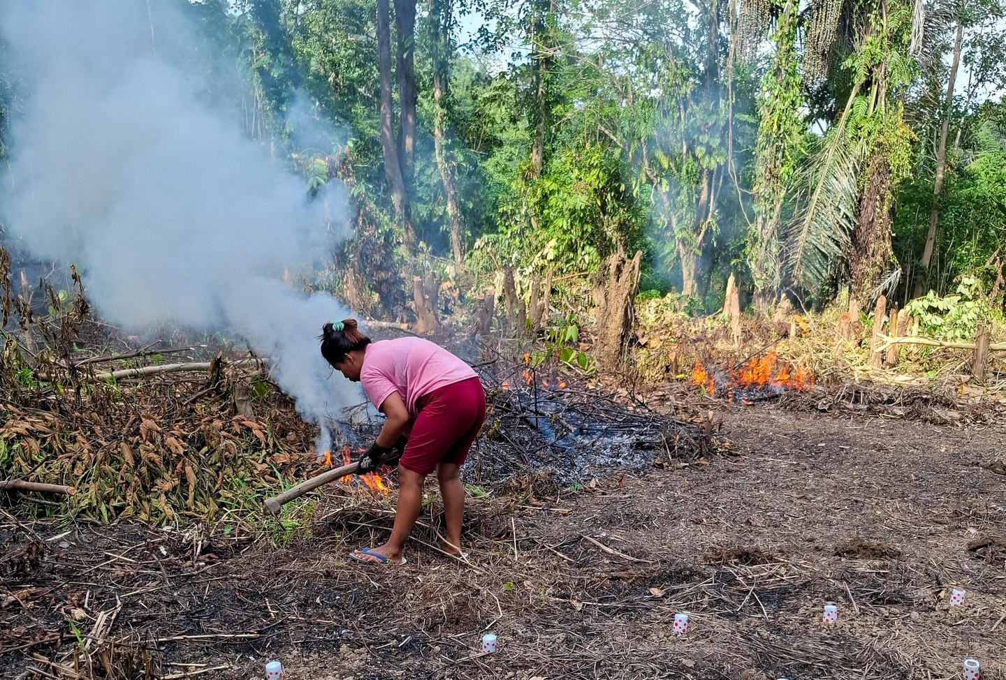 Community member tending fire in Sulawesi