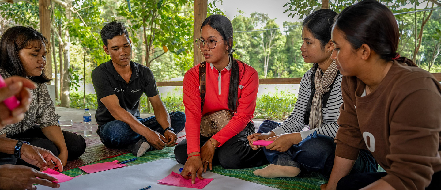 Young people discussing forest conservation and management.